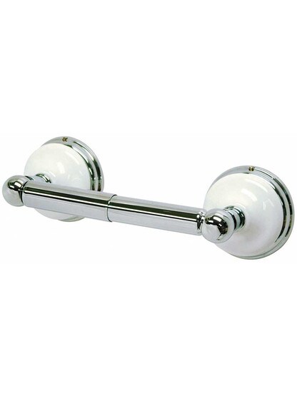 Cumberland Toilet Paper Holder with Brass and White Porcelain Rosettes in Polished Chrome.